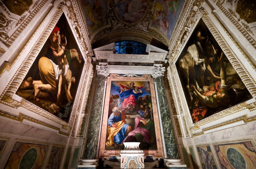 View of the Cerasi Chapel with Annibale Carracci’s altarpiece, The Assumption of the Virgin and 'The Crucifixion of St. Peter' on the left, and The Conversion of Paul on the right both by Caravaggio 